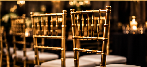 Gold Chiavari chairs arranged for an event