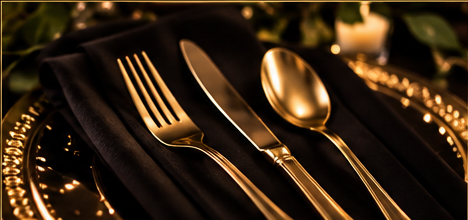 Gold cutlery set on a black napkin